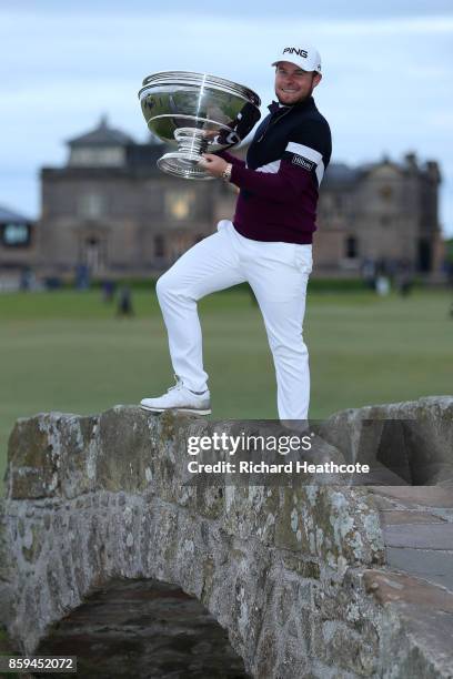 Tyrrell Hatton of England celebrates victory with the trophy on the Swilken Bridge following the final round of the 2017 Alfred Dunhill Championship...