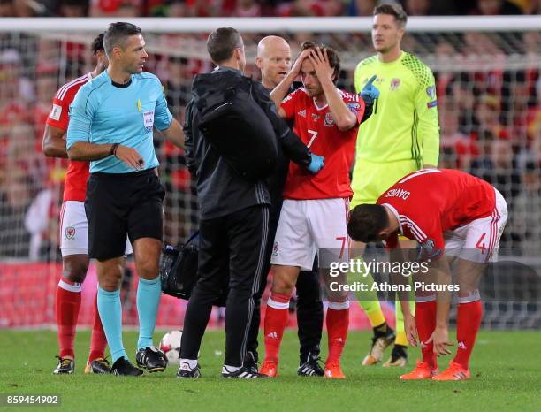Wales physiotherapists see to Joe Allen who suffered a suspected head injury during the FIFA World Cup Qualifier Group D match between Wales and...