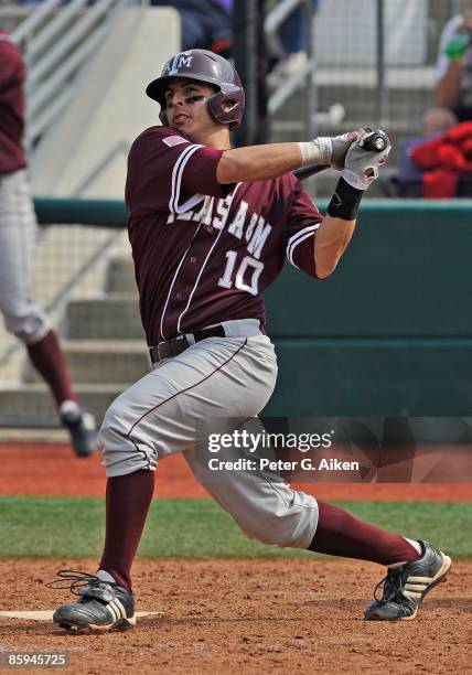 Catcher Kevin Gonzalez of the Texas A&M Aggies drives the ball to left field against the Kansas State Wildcats at Tointon Stadium on April 11, 2009...