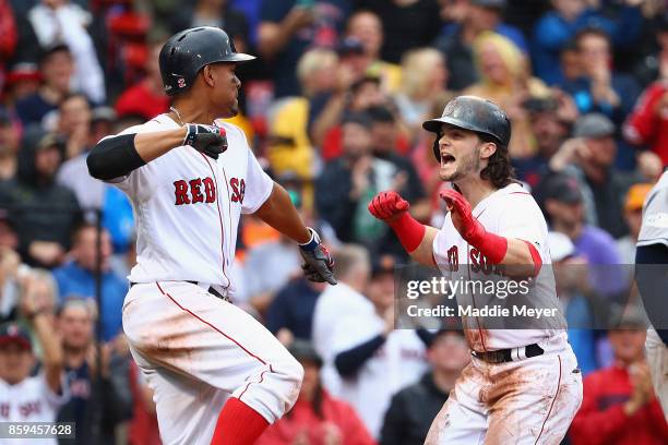 Andrew Benintendi of the Boston Red Sox celebrates with Xander Bogaerts after hitting a two-run home run in the fifth inning against the Houston...