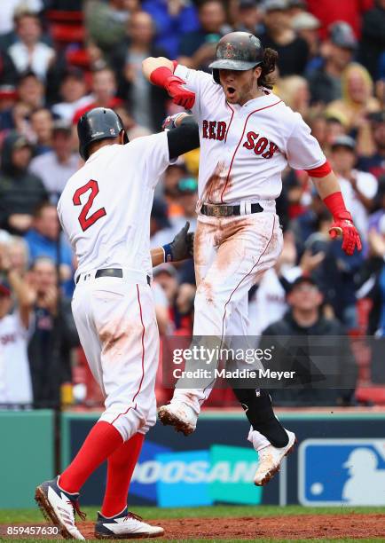 Andrew Benintendi of the Boston Red Sox celebrates with Xander Bogaerts after hitting a two-run home run in the fifth inning against the Houston...