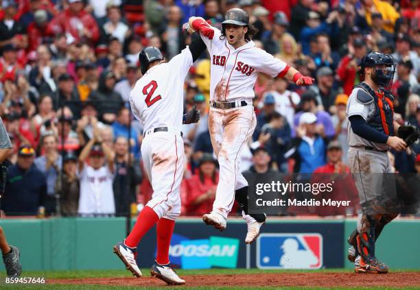 Andrew Benintendi of the Boston Red Sox celebrates with Xander Bogaerts after hitting a two-run home run in the fifth inning against the Houston...