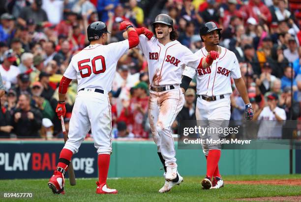 Andrew Benintendi of the Boston Red Sox celebrates with Mookie Betts after hitting a two-run home run in the fifth inning against the Houston Astros...