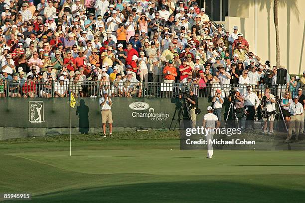 Camilo Villegas is greeted by fans on the 18th hole in action during the fourth round of the Ford Championship at Doral Golf Resort and Spa in Miami,...