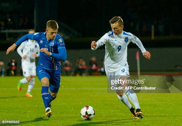 Iceland's forward Johann Berg Gudmundsson and Kosovo's Bersant Celina vie for the ball during the FIFA World Cup 2018 qualification football match...