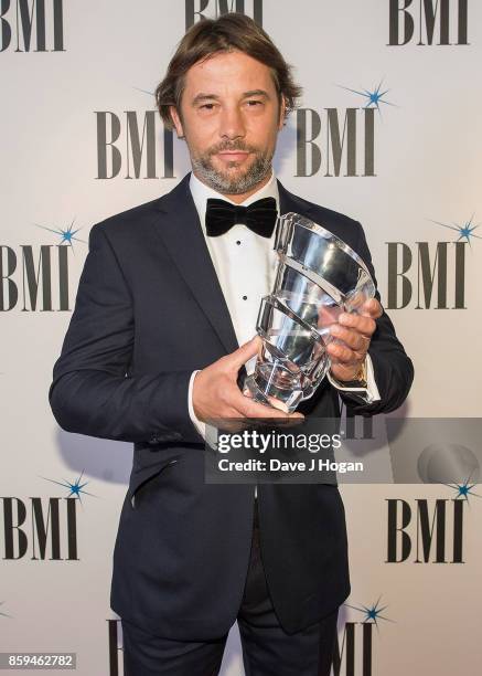 Jay Kay of Jamiroquai poses with the BMI President's Award which he was awarded at the BMI London Awards at The Dorchester on October 9, 2017 in...