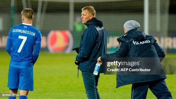 Iceland's coach Heimir Hallgrimsson stands speaks with Iceland's forward Johann Berg Gudmundsson on the sidelines during the FIFA World Cup 2018...