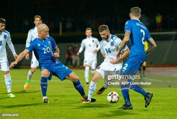 Iceland's Emil Hallfredsson and Kosovo's Valon Berisha vie for the ball during the FIFA World Cup 2018 qualification football match between Iceland...