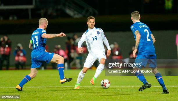 Iceland's midfielder Aron Gunnarsson , Iceland's defender Birkir Saevarsson and Kosovo's Leart Paqarada vie for the ball during the FIFA World Cup...