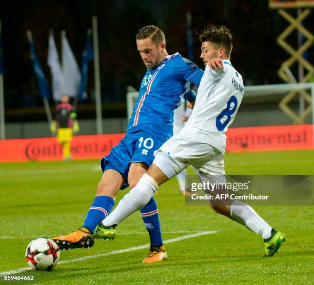 Iceland's midfielder Gylfi Sigurdsson and Kosovo's Besar Halimi vie for the ball during the FIFA World Cup 2018 qualification football match between...
