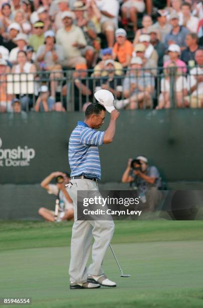 Tiger Woods tips his hat on the 18th green during the third round of the Ford Championship at Doral held on the Blue Course at Doral Golf Resort and...