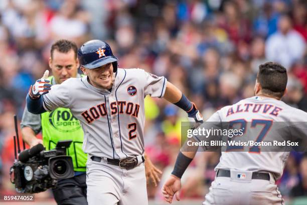 Alex Bregman of the Houston Astros reacts with Jose Altuve after hitting a game tying solo home run during the eighth inning of game four of the...