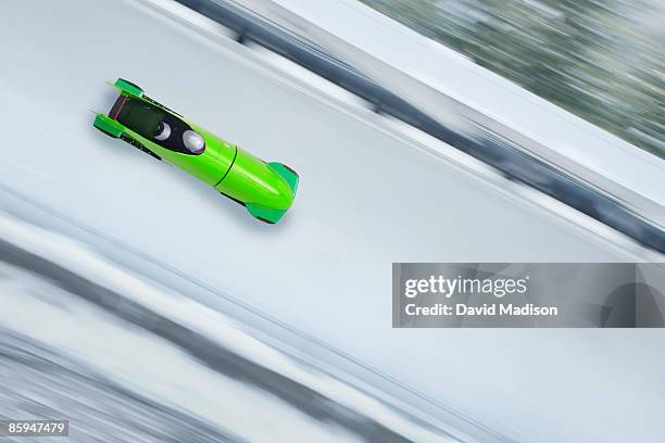 bobsled on track with motion blur. - bobsleigh stockfoto's en -beelden