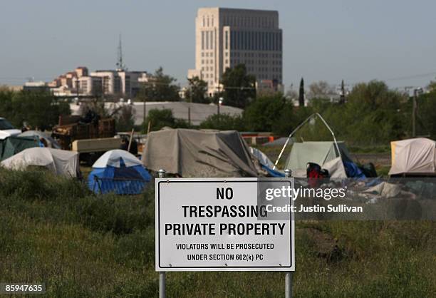 No trespassing sign is posted at a homeless tent city April 13, 2009 in Sacramento, California. Hundreds of residents living in a tent city along the...