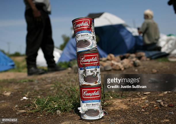 Cans of beef broth are stacked at a homeless tent city April 13, 2009 in Sacramento, California. Hundreds of residents living in a tent city along...