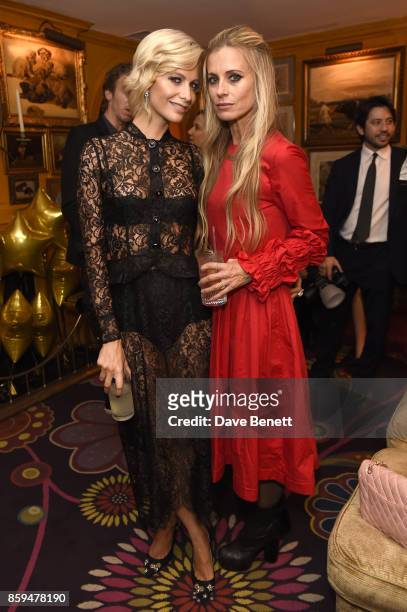 Poppy Delevingne and Laura Bailey attend the Conde Nast Traveller 20th anniversary after party at Annabel's on October 9, 2017 in London, England.