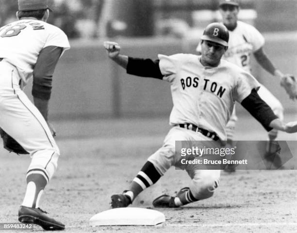 Carl Yastrzemski of the Boston Red Sox slides safely into third base as Mike Shannon of the St. Louis Cardinals awaits the throw during Game 4 of the...