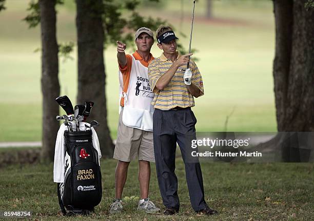 Brad Faxon confers with his caddie on the 13th hole during the third round of the Southern Farm Bureau Classic at Annandale Golf Club in Madison,...