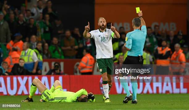 Ireland captain David Meyler recieves a yellow card for a foul on goalkeeper Wayne Hennessey during the FIFA 2018 World Cup Qualifier between Wales...