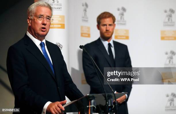 Britain's Prince Harry and Secretary of State for Defense Michael Fallon, left, present the Employer Recognition Scheme Gold Awards at the Imperial...
