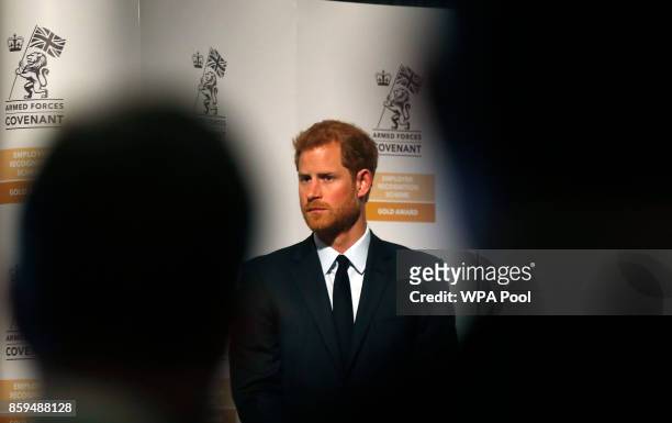 Britain's Prince Harry looks on as he presents the Employer Recognition Scheme Gold Awards at the Imperial War Museum on October 9, 2017 in London,...