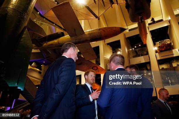 Britain's Prince Harry speaks to award winners after he presented the Employer Recognition Scheme Gold Awards at the Imperial War Museum on October...