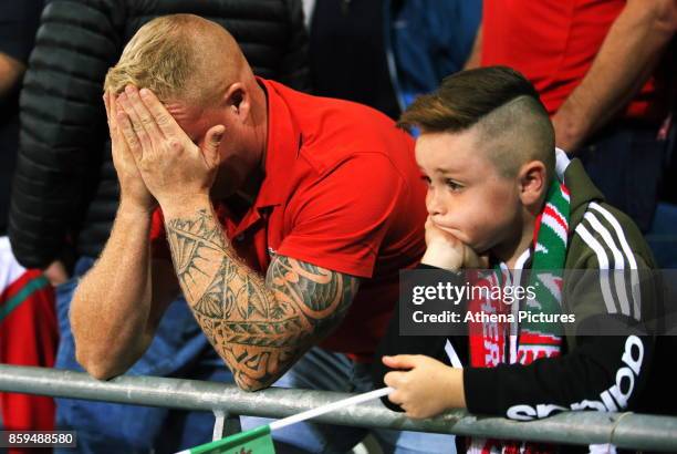 Wales supporters watch the game in disappointment after conceding a goal during the FIFA World Cup Qualifier Group D match between Wales and Republic...