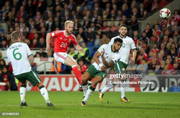 Jonathan Williams of Wales shoots the ball off target while closely marked by Glenn Whelan and Cyrus Christie of Ireland during the FIFA World Cup...