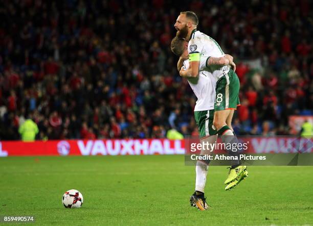 James McClean of Ireland celebrates with team captain David Meyler during the FIFA World Cup Qualifier Group D match between Wales and Republic of...