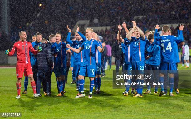 Iceland's team celebrate after the FIFA World Cup 2018 qualification football match between Iceland and Kosovo in Reykjavik, Iceland on October 9,...