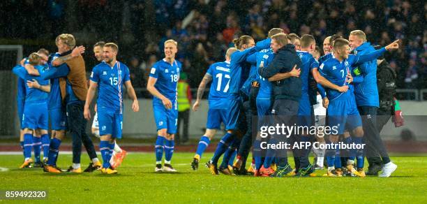 Iceland's team celebrate after the FIFA World Cup 2018 qualification football match between Iceland and Kosovo in Reykjavik, Iceland on October 9,...