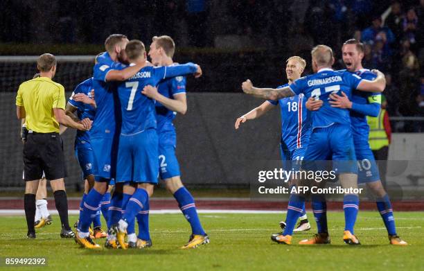 Iceland's players celebrate after the FIFA World Cup 2018 qualification football match between Iceland and Kosovo in Reykjavik, Iceland on October 9,...