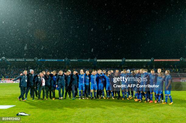 Iceland's team celebrate after the FIFA World Cup 2018 qualification football match between Iceland and Kosovo in Reykjavik, Iceland on October 9,...