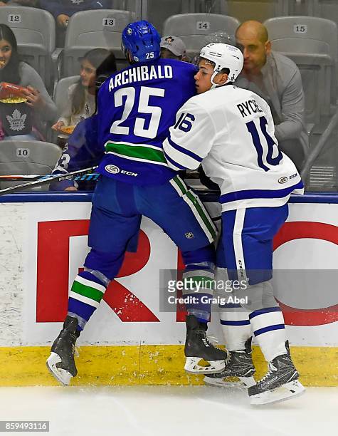 Kerby Rychel of the Toronto Marlies throws a hit on Darren Archibald of the Utica Comets during AHL game action on October 7, 2017 at Ricoh Coliseum...