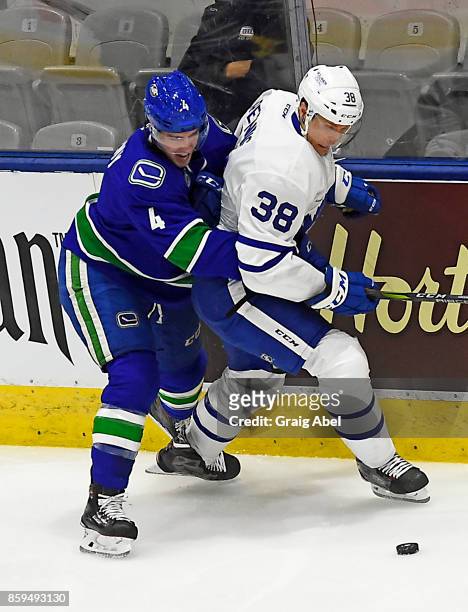 Colin Greening of the Toronto Marlies battles for the puck with Evan McEneny during AHL game action on October 7, 2017 at Ricoh Coliseum in Toronto,...