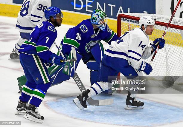 Adam Brooks of the Toronto Marlies battles for crease space with Jordan Subban and Thatcher Demko of the Utica Comets with during AHL game action on...