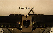 Text Story begins typed on retro typewriter