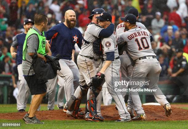 Ken Giles of the Houston Astros celebrates with Brian McCann after recording the final out in the ninth inning to defeat the Boston Red Sox 5-4 in...