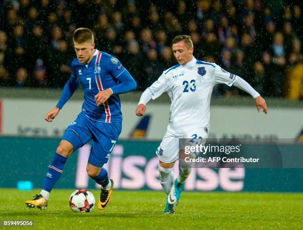 Iceland's forward Johann Berg Gudmundsson and Kosovo's Bernard Berisha vie for the ball during the FIFA World Cup 2018 qualification football match...