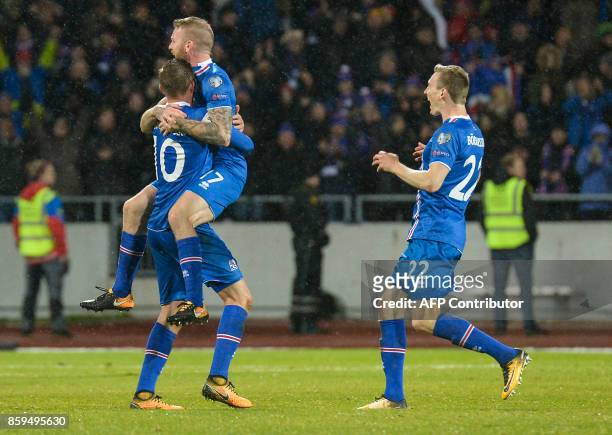 Iceland's midfielder Gylfi Sigurdsson, Iceland's midfielder Aron Gunnarsson and Iceland's forward Jon Dadi Bodvarsson celebate at the FIFA World Cup...