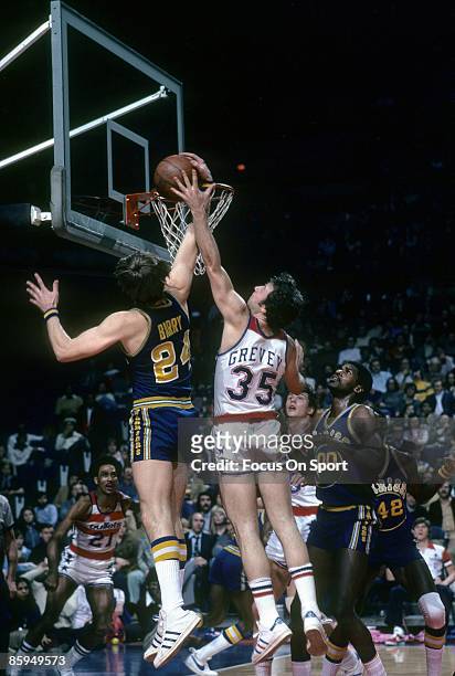 S: Rick Barry of the Golden State Warriors battle for a rebound with Kevin Grevey of the Washington Bullets during a mid circa 1970's NBA basketball...