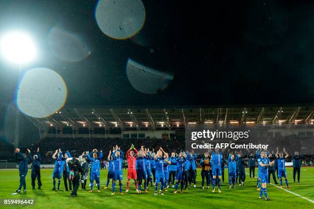 Iceland's team celebrate after the FIFA World Cup 2018 qualification football match between Iceland and Kosovo in Reykjavik, Iceland on October 9,...