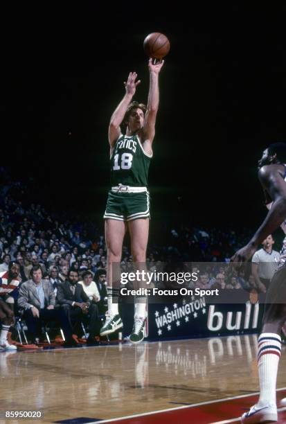 S: Dave Cowens of the Boston Celtics shoots in front of Elvin Hayes of the Washington Bullets during a early circa 1970 NBA basketball game at the...