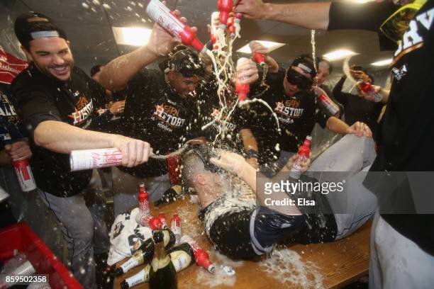 Ken Giles of the Houston Astros celebrates with teammates in the clubhouse after defeating the Boston Red Sox 5-4 in game four of the American League...