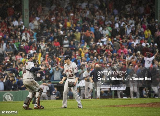 Ken Giles and Brian McCann of the Houston Astros celebrate after defeating the Boston Red Sox 5-4 in game four of the American League Division Series...