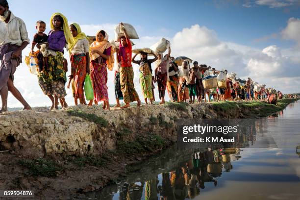 Hundreds of Rohingya people crossing Bangladesh's border as they flee from Buchidong at Myanmar after crossing the Naf River in Bangladesh. According...