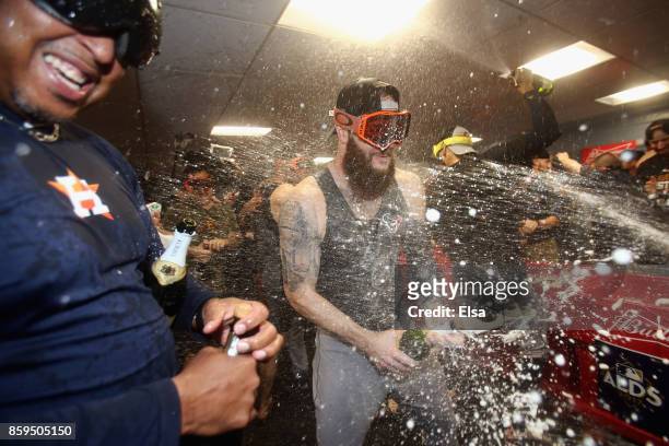 Dallas Keuchel of the Houston Astros celebrates with teammates in the clubhouse after defeating the Boston Red Sox 5-4 in game four of the American...