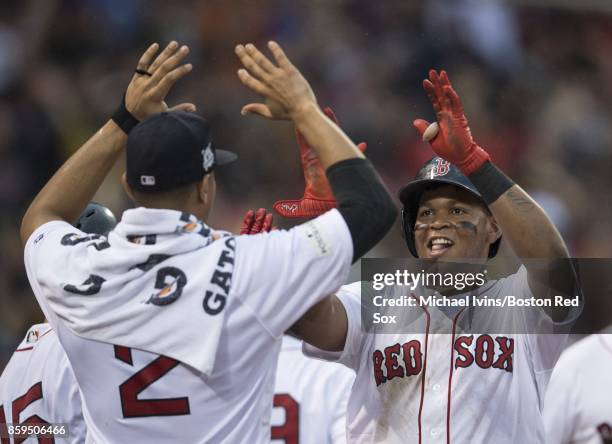 Rafael Devers of the Boston Red Sox reacts after hitting an inside-the-park home run against the Houston Astros in the ninth inning of game four of...