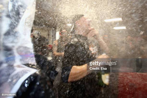 Manager A.J. Hinch of the Houston Astros celebrates in the clubhouse after defeating the Boston Red Sox 5-4 in game four of the American League...