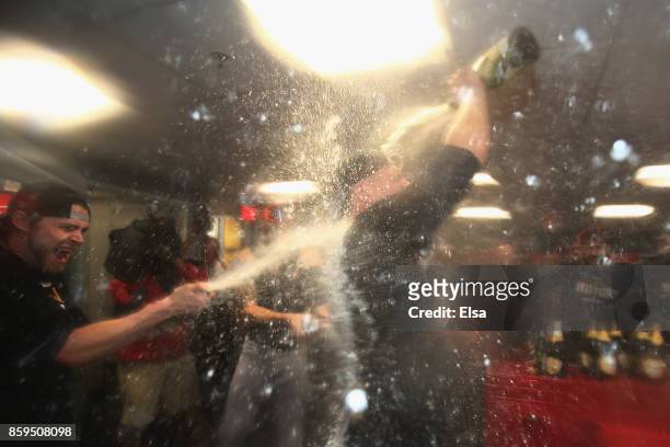Manager A.J. Hinch of the Houston Astros celebrates in the clubhouse after defeating the Boston Red Sox 5-4 in game four of the American League...